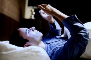 35444985 - man using his mobile phone in the bed